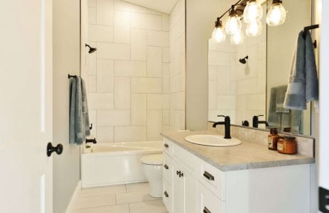 Upstairs bathroom with vaulted ceiling and custom floor-to-ceiling tile
