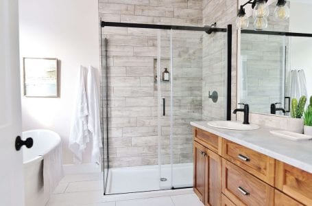 Master Suite Bathroom with custom cabinetry, custom tile shower and free-standing tub