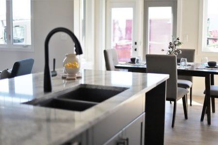 The Alameda 2450 silgranit kitchen sink overlooks the household with views of the living room, dining room, and outside.