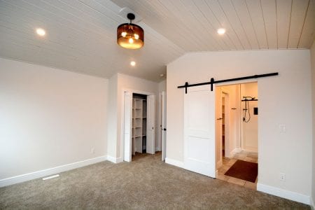 Glacial Shores 2403 Master suite has 2 walk-in closets and a barn door to the luxury ensuite